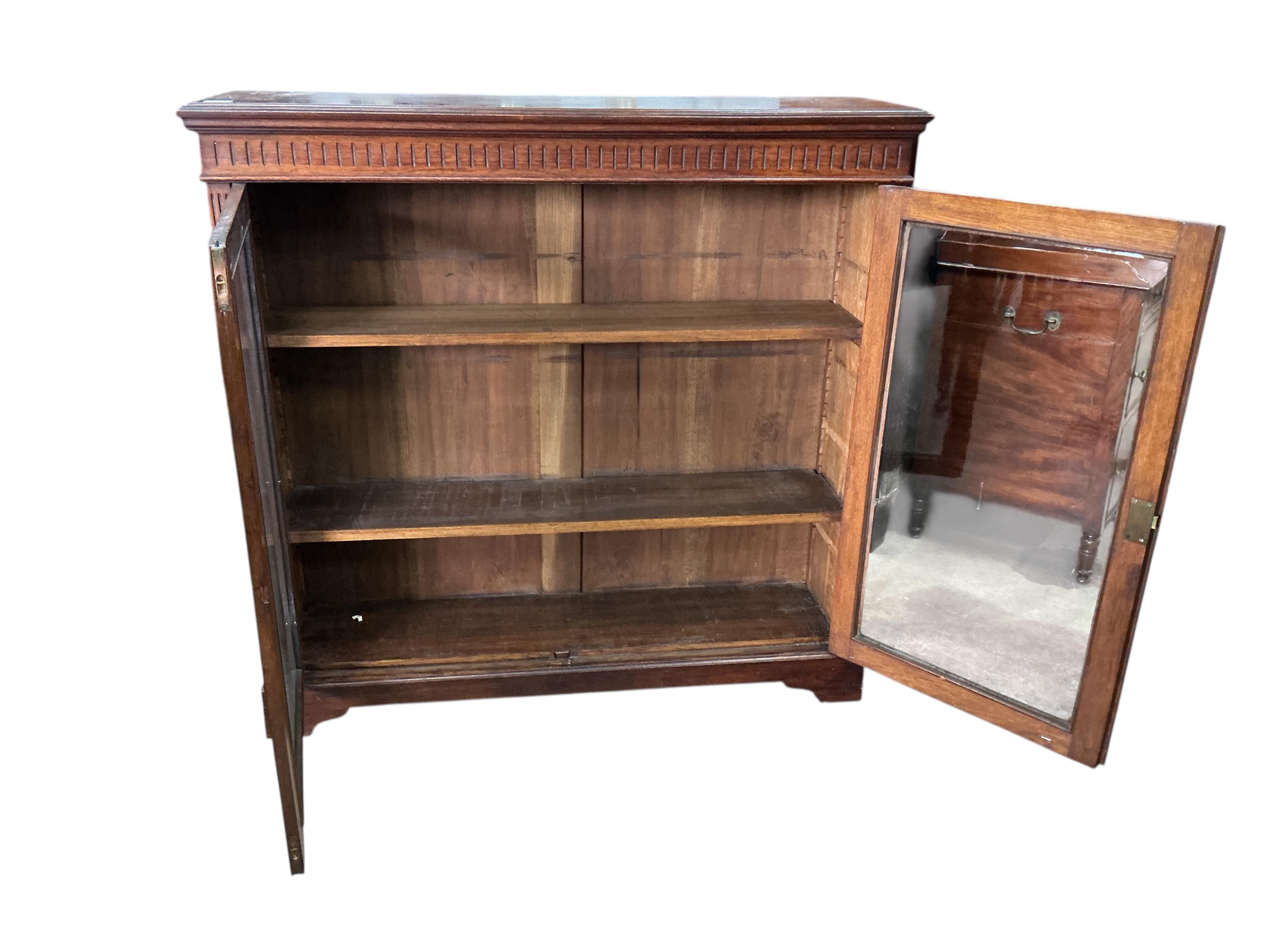 A late Victorian glazed oak bookcase, width 122cm, depth 33cm, height 118cm